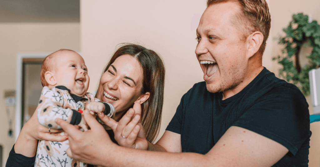 Happy Parents Holding Their Baby in a Houston Apartment | Dallas Apartment Locators | Free Service | Call 972 818 3456